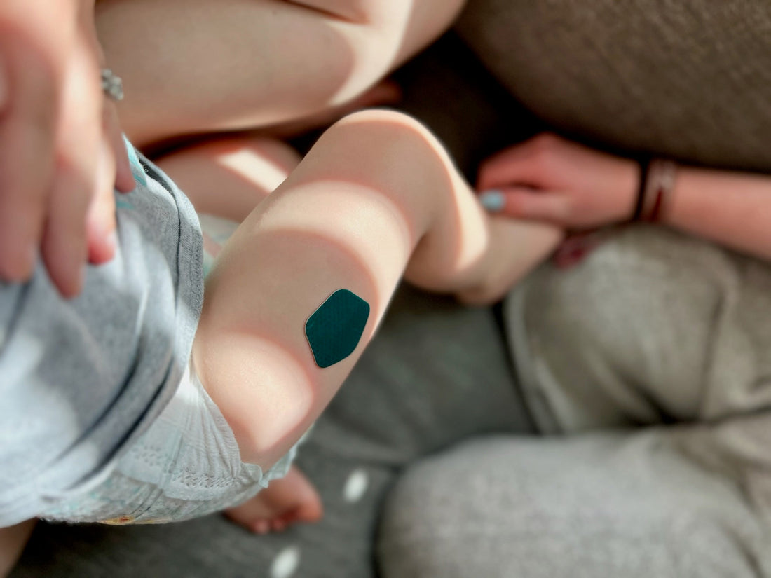 Baby wearing Thimble Recover patch after vaccine