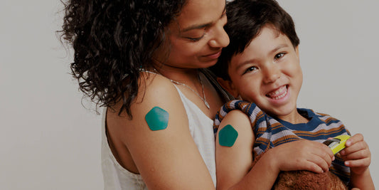 Mother and child wearing Recover patches after flu shots